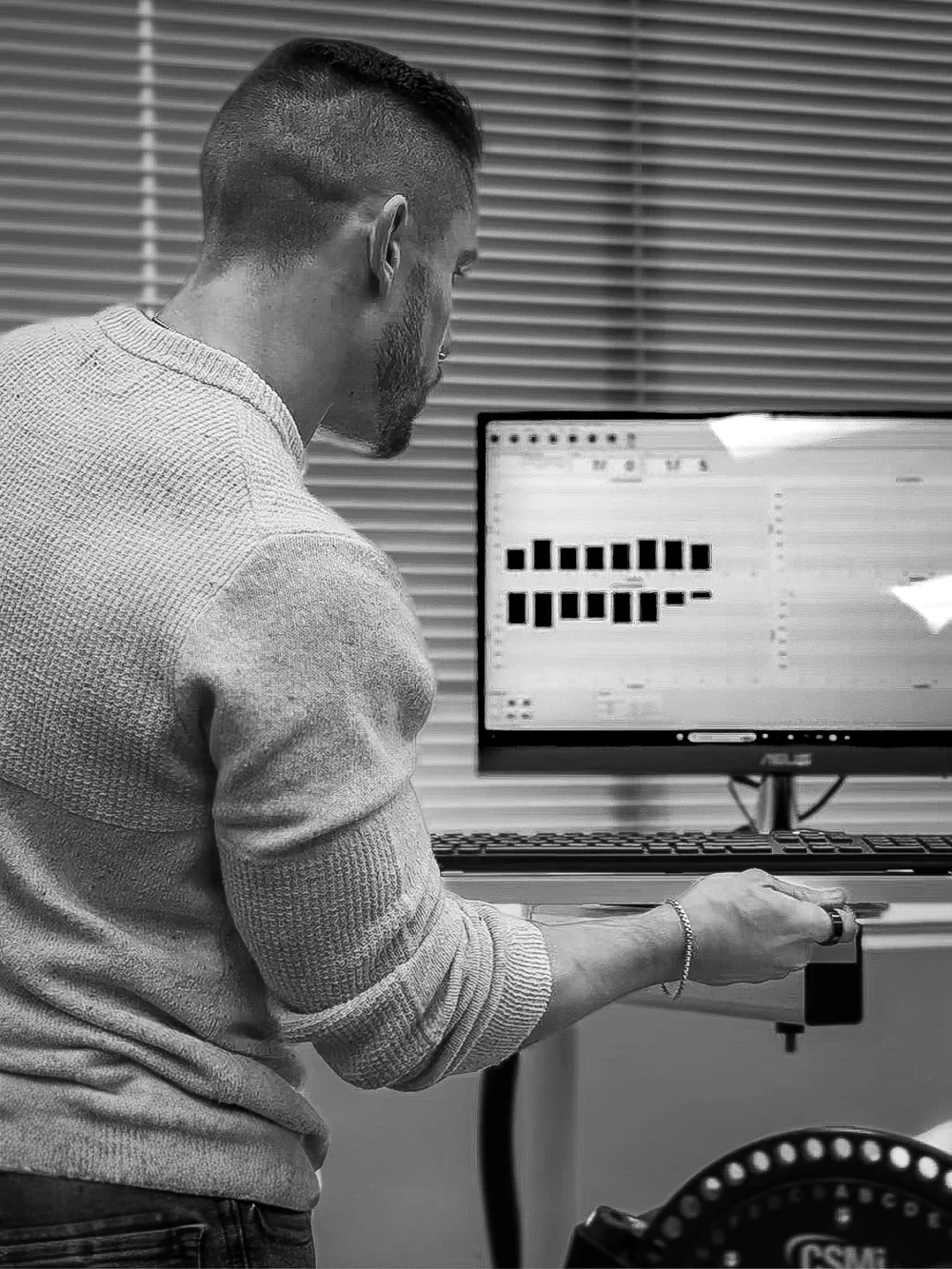 MOVE LAB clinician reviewing force plate data on a monitor in the lab